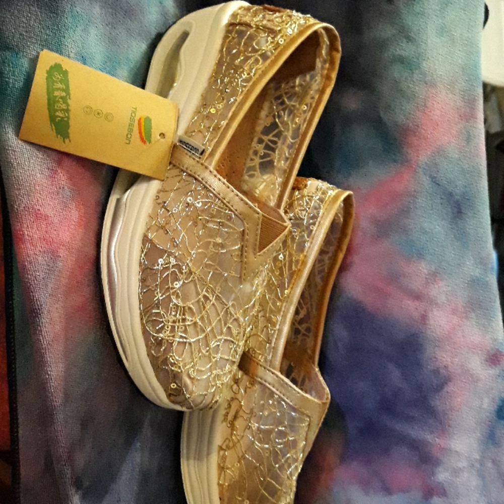 Pair of gold slip on shoes